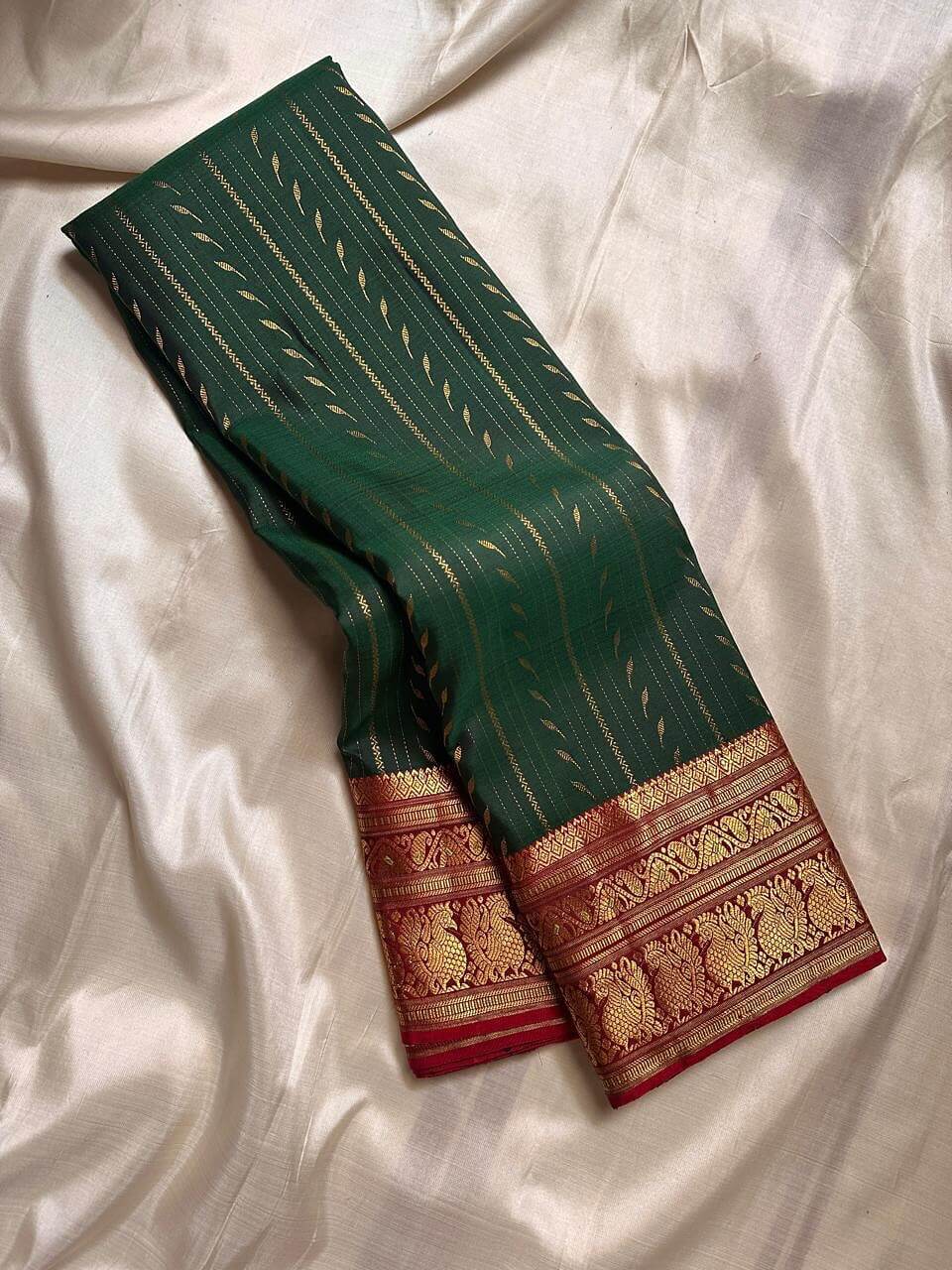 Gossamer Dark Green Soft Silk Saree With Eye-catching Blouse Piece