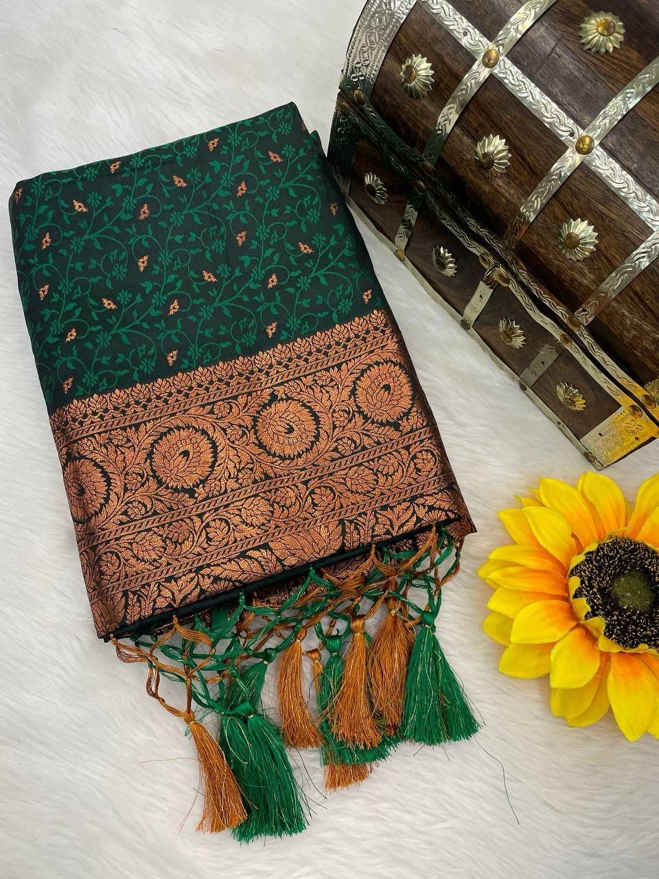 Staring Dark Green Soft Banarasi Silk Saree With Zephyr Blouse Piece