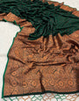 Staring Dark Green Soft Banarasi Silk Saree With Zephyr Blouse Piece